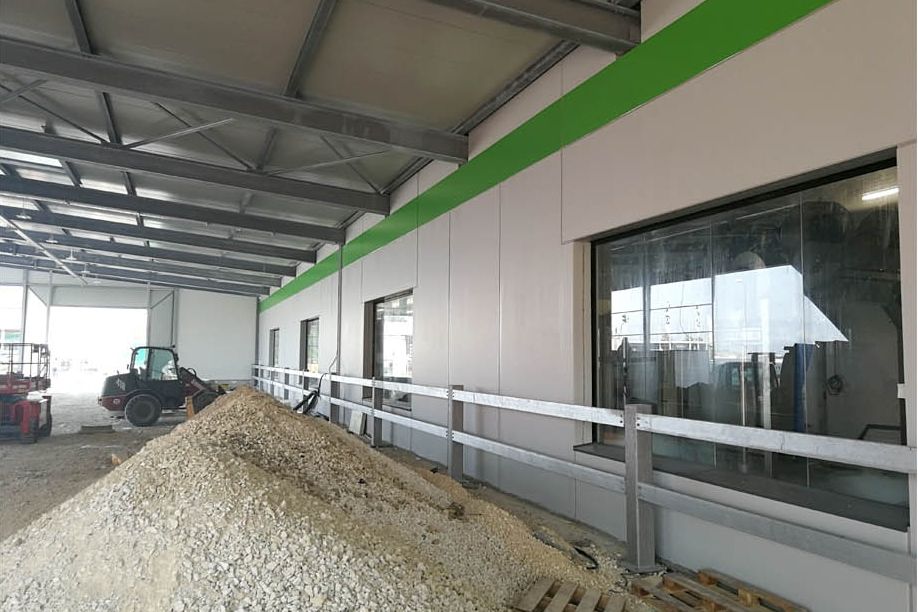Hallenneubau mit Fassadenpaneelen und Fensteröffnungen vor der Verfugung